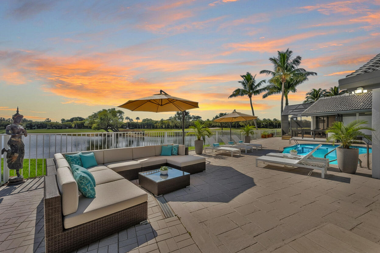10722 Kirkaldy Lane Boca Raton, FL 33498 - Photo 4 of 76 a view of a patio with couches and a table and chairs with wooden floor