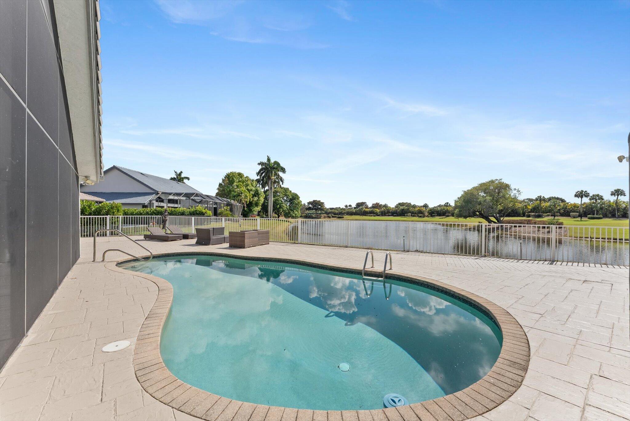 10722 Kirkaldy Lane Boca Raton, FL 33498 - Photo 41 of 76 a swimming pool with outdoor seating and wooden floor