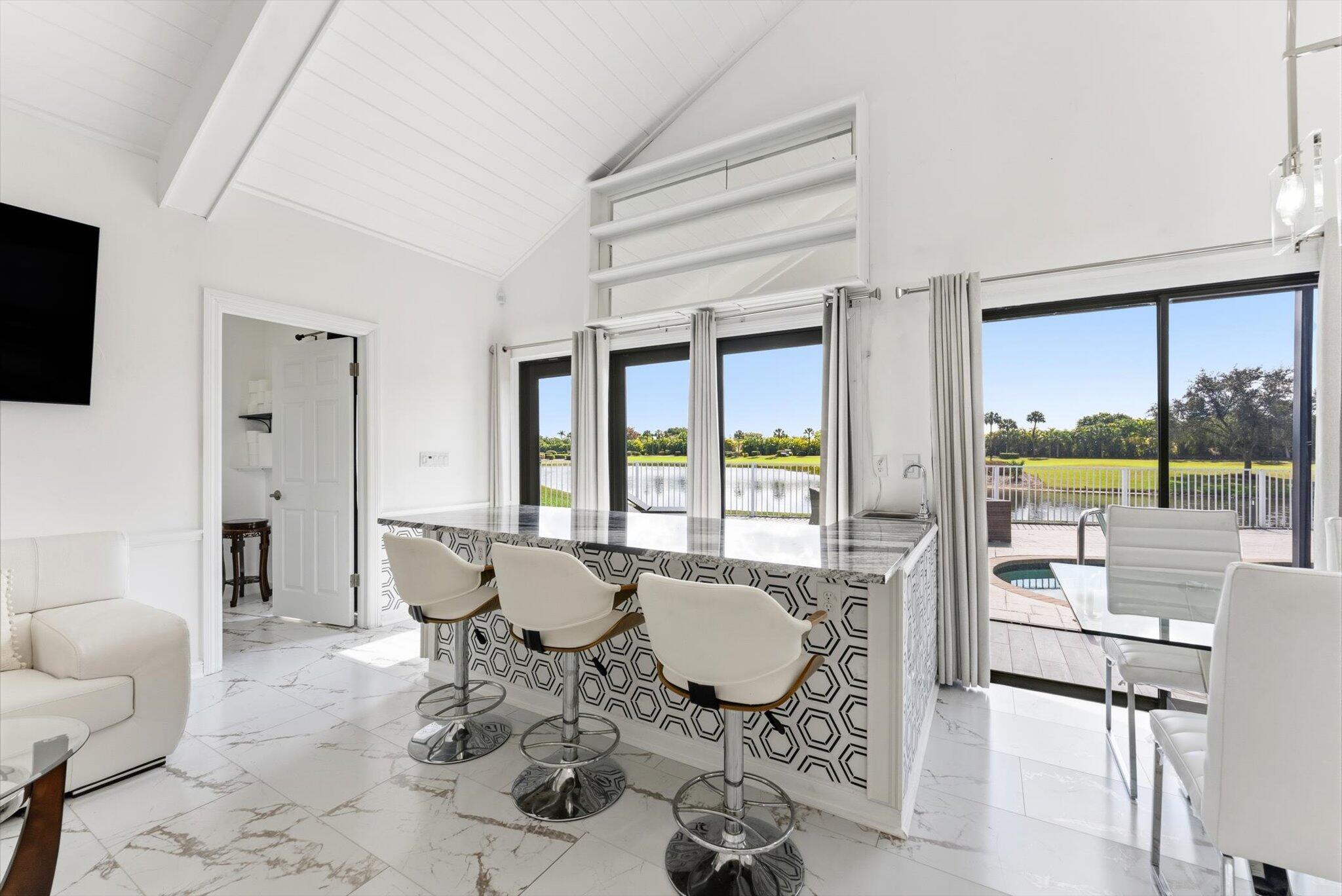 10722 Kirkaldy Lane Boca Raton, FL 33498 - Photo 7 of 76 a living room with furniture a flat screen tv and a large window
