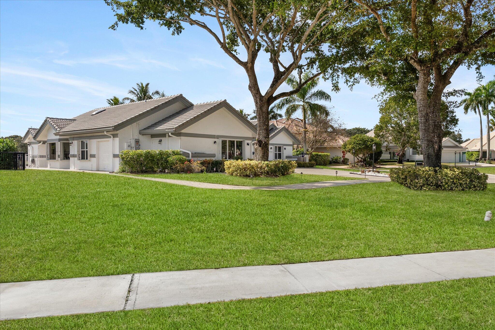 10722 Kirkaldy Lane Boca Raton, FL 33498 - Photo 75 of 76 a front view of a house with a yard