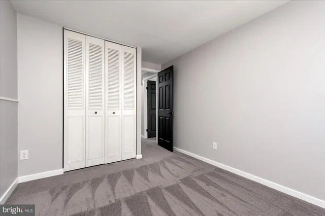 a view of an empty room with closet
