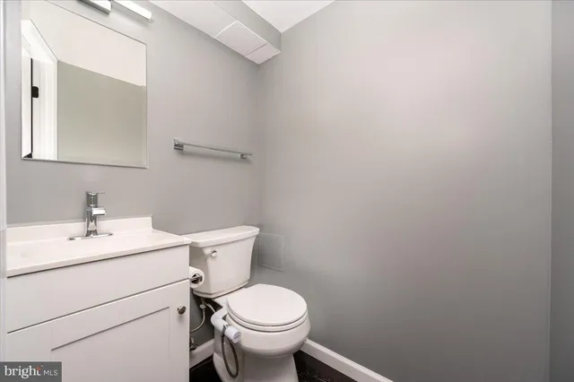 a bathroom with a sink toilet and a mirror