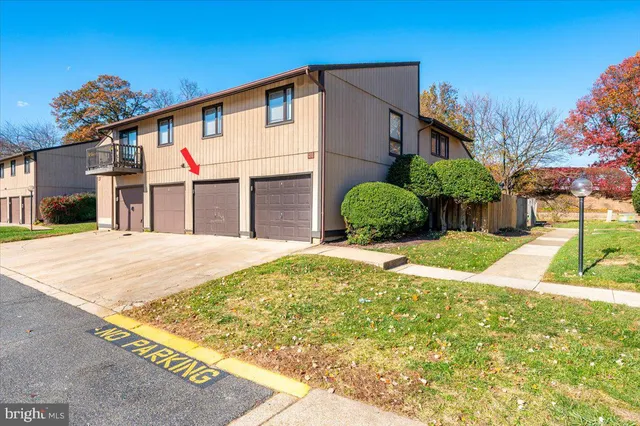 a view of a white house with a yard
