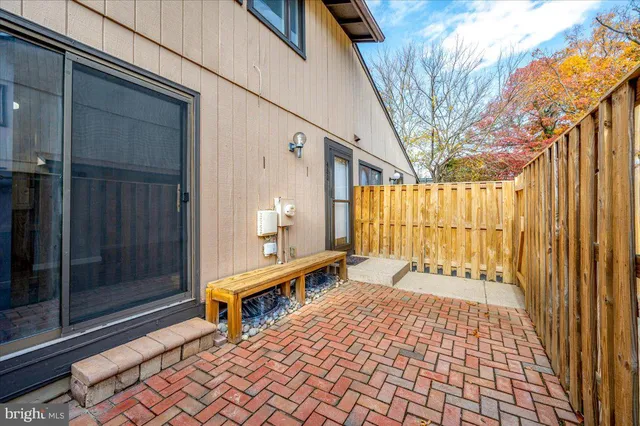 a porch with a table and chairs