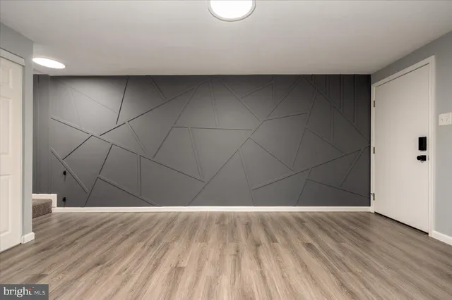 a view of a room with wooden floor