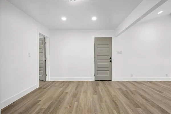 an empty room with wooden floor