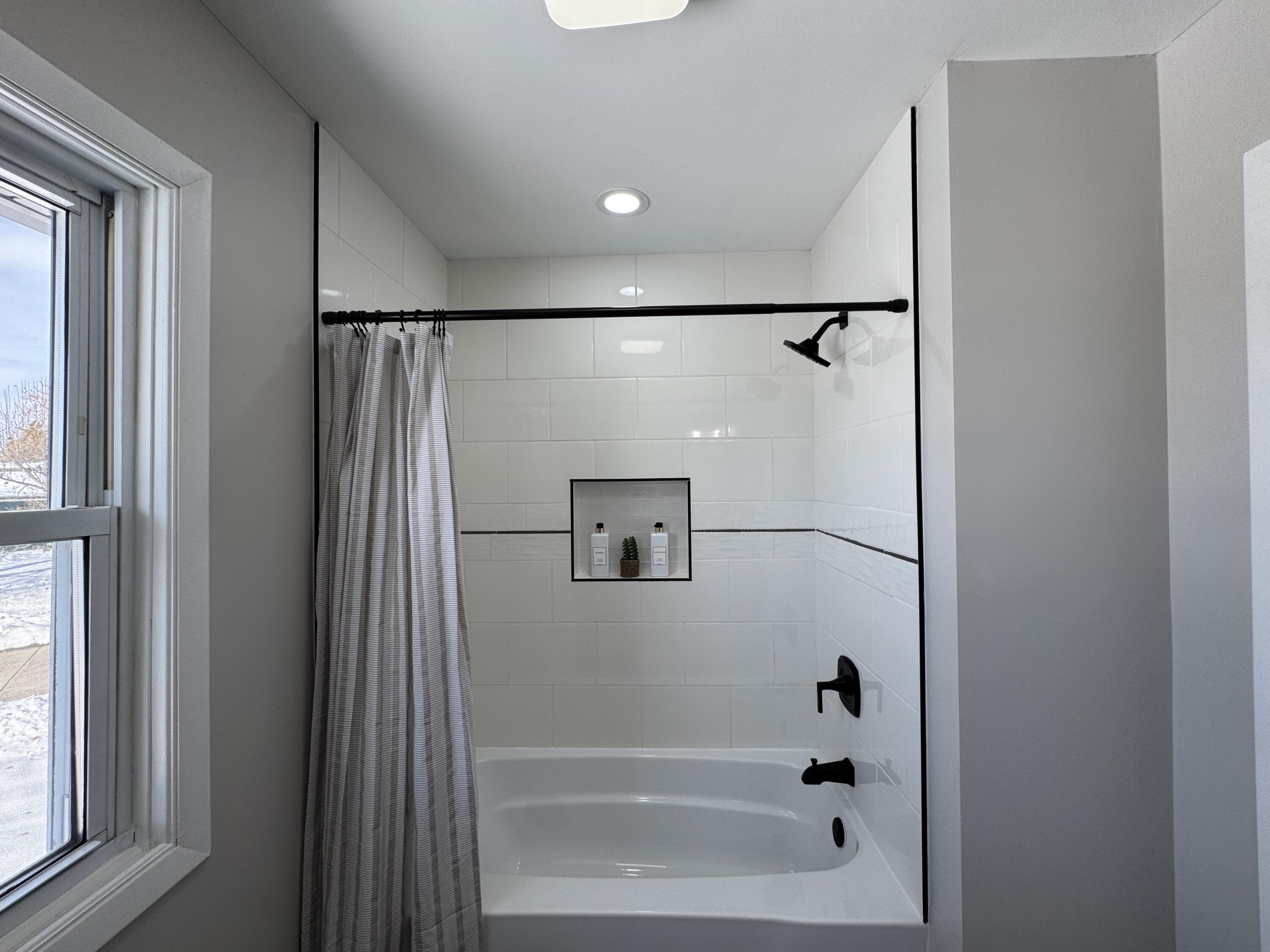 9383 Roosevelt Street Crown Point, IN 46307 - Photo 12 of 20 a bathroom with a shower and a bath tub