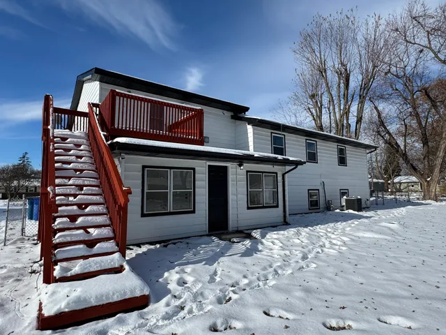a view of a house with a snow in the yard