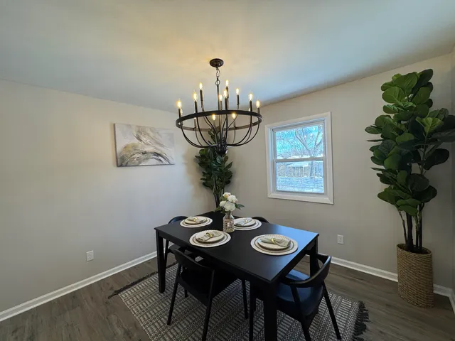 a view of a dining room with furniture wooden floor and chandelier