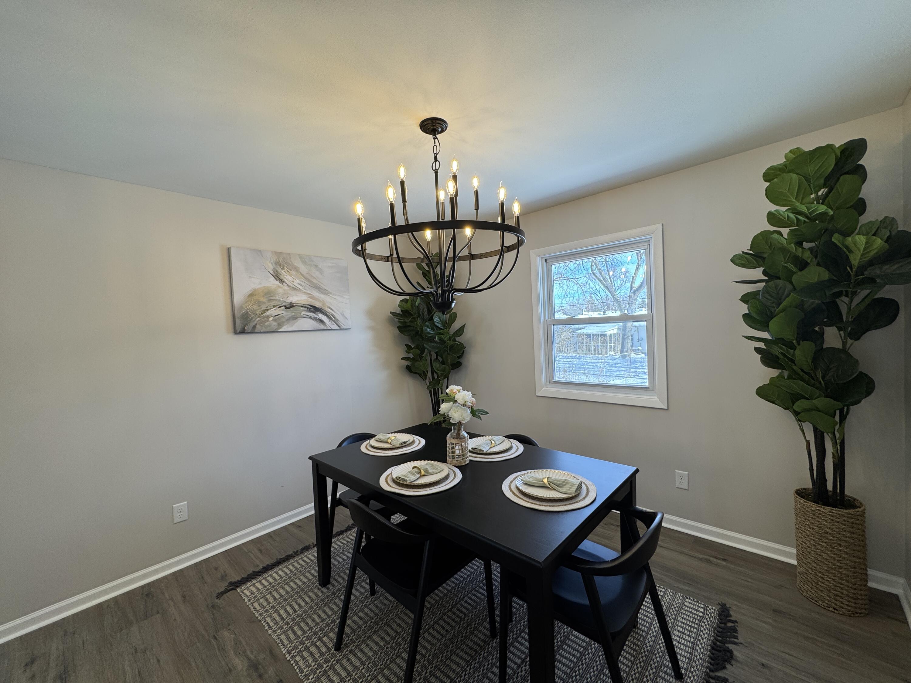 9383 Roosevelt Street Crown Point, IN 46307 - Photo 6 of 20 a view of a dining room with furniture wooden floor and chandelier
