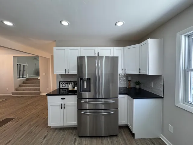 a kitchen with stainless steel appliances a refrigerator sink and cabinets