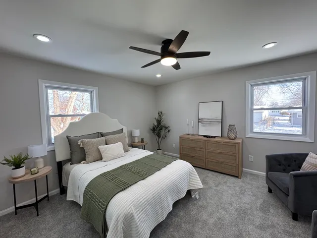 a bedroom with a large bed and a window