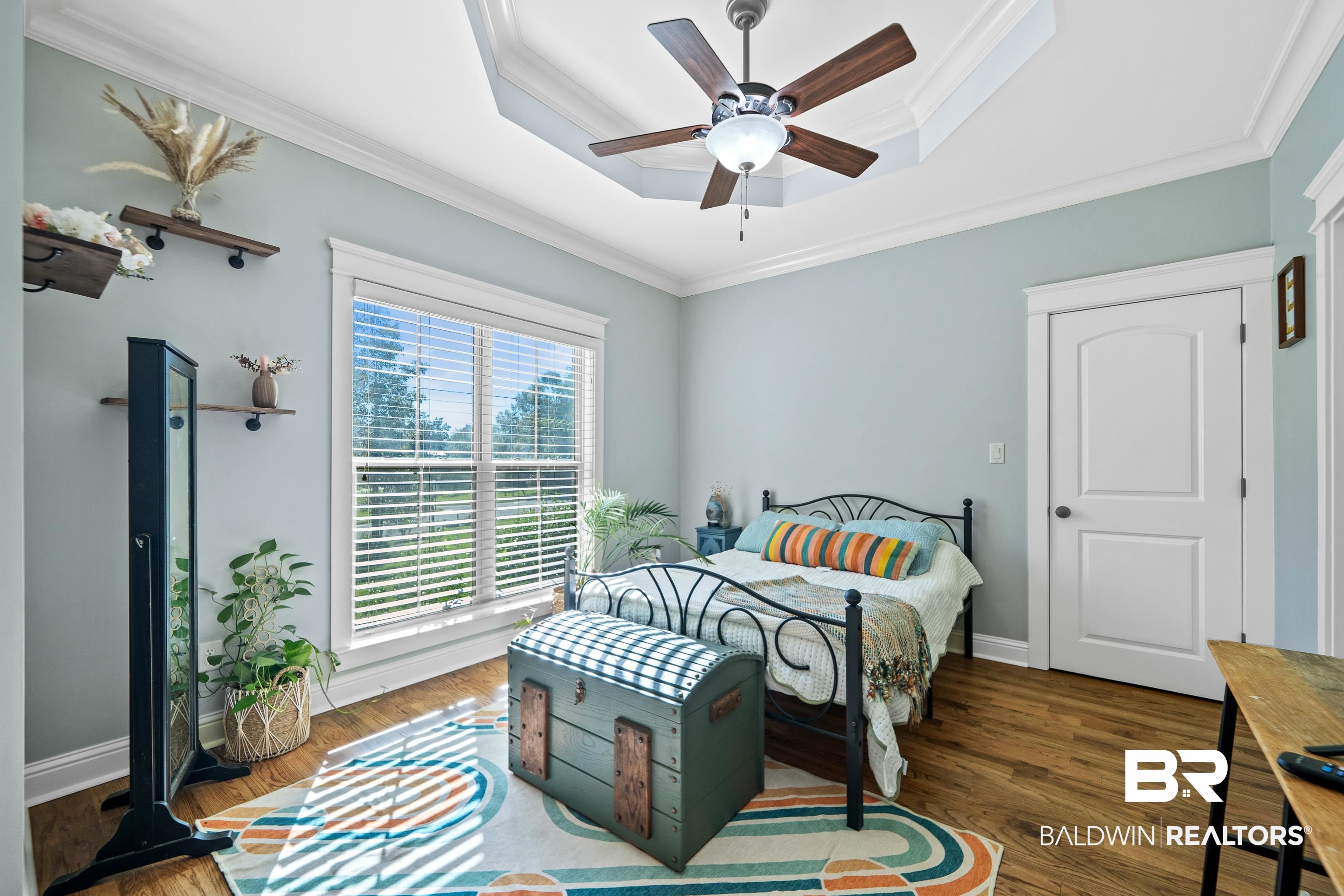 31829 Butler Drive Daphne, AL 36527 - Photo 29 of 48 Bedroom with a tray ceiling, ornamental molding, dark wood-type flooring, and ceiling fan