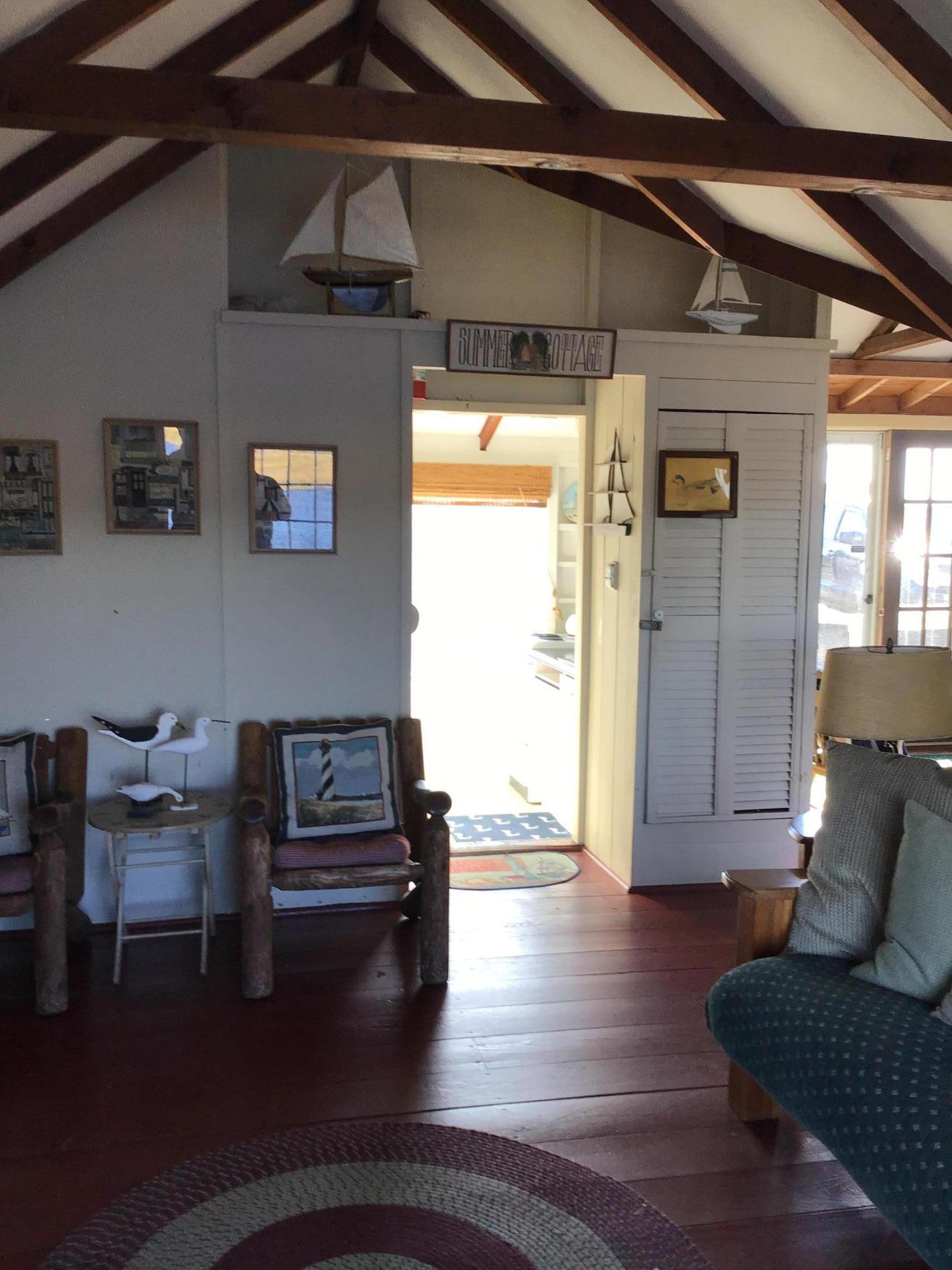 10 Lower County Road Dennis Port, MA 02639 - Photo 12 of 25 a living room with furniture and a wooden floor
