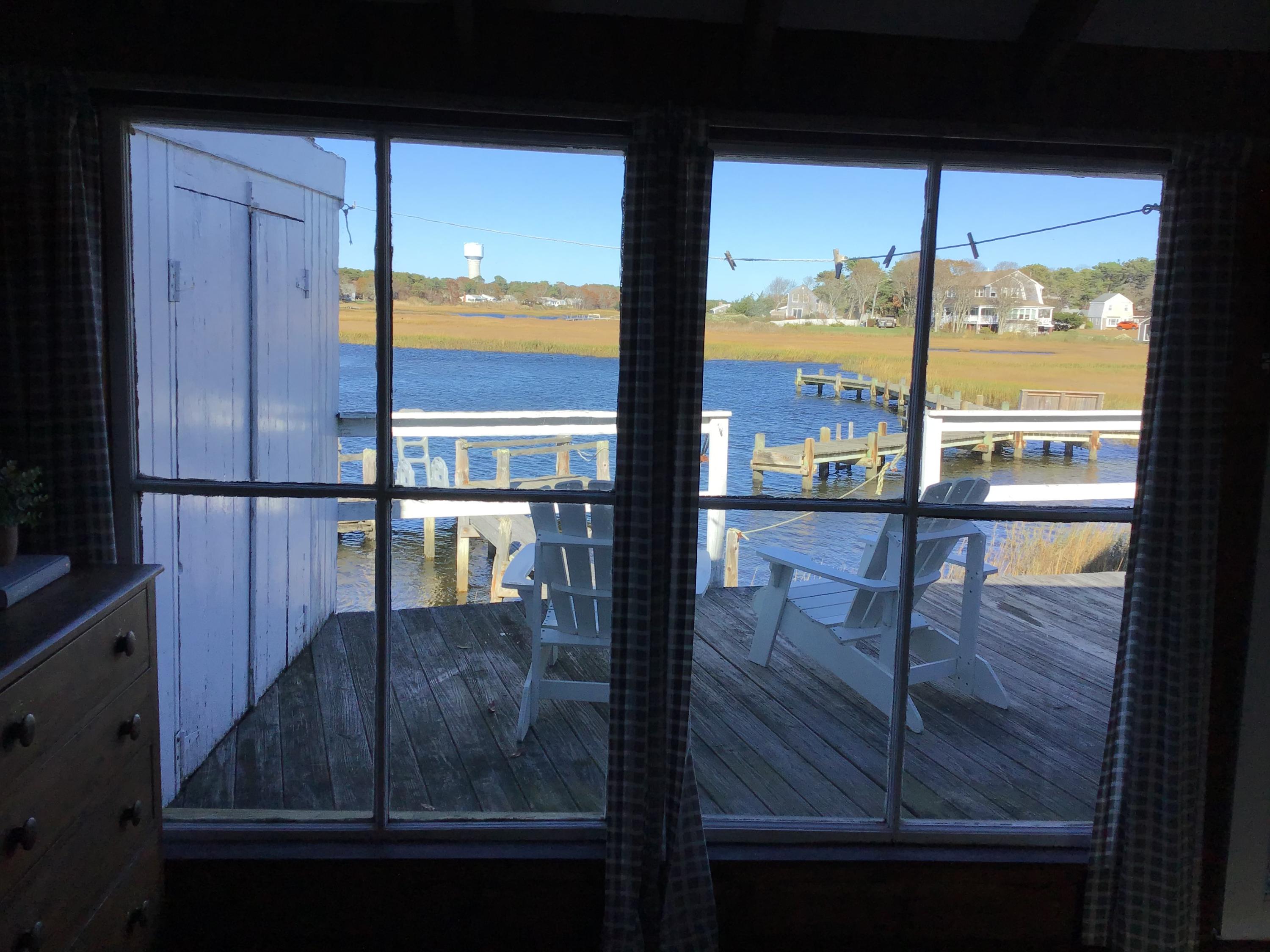 10 Lower County Road Dennis Port, MA 02639 - Photo 16 of 25 a room with wooden floor and windows