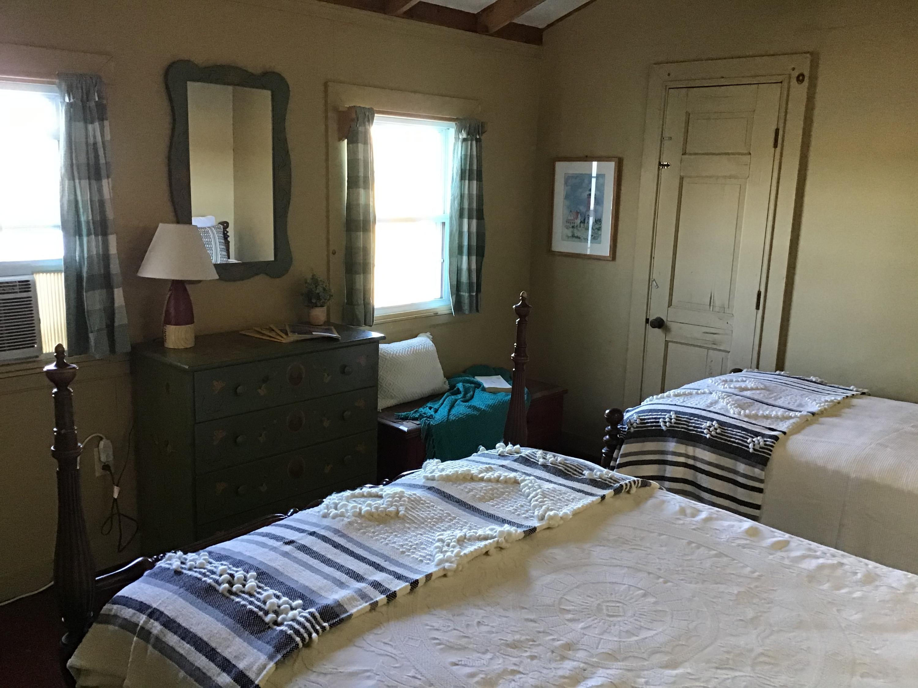 10 Lower County Road Dennis Port, MA 02639 - Photo 18 of 25 a bedroom with a bed and wooden floor