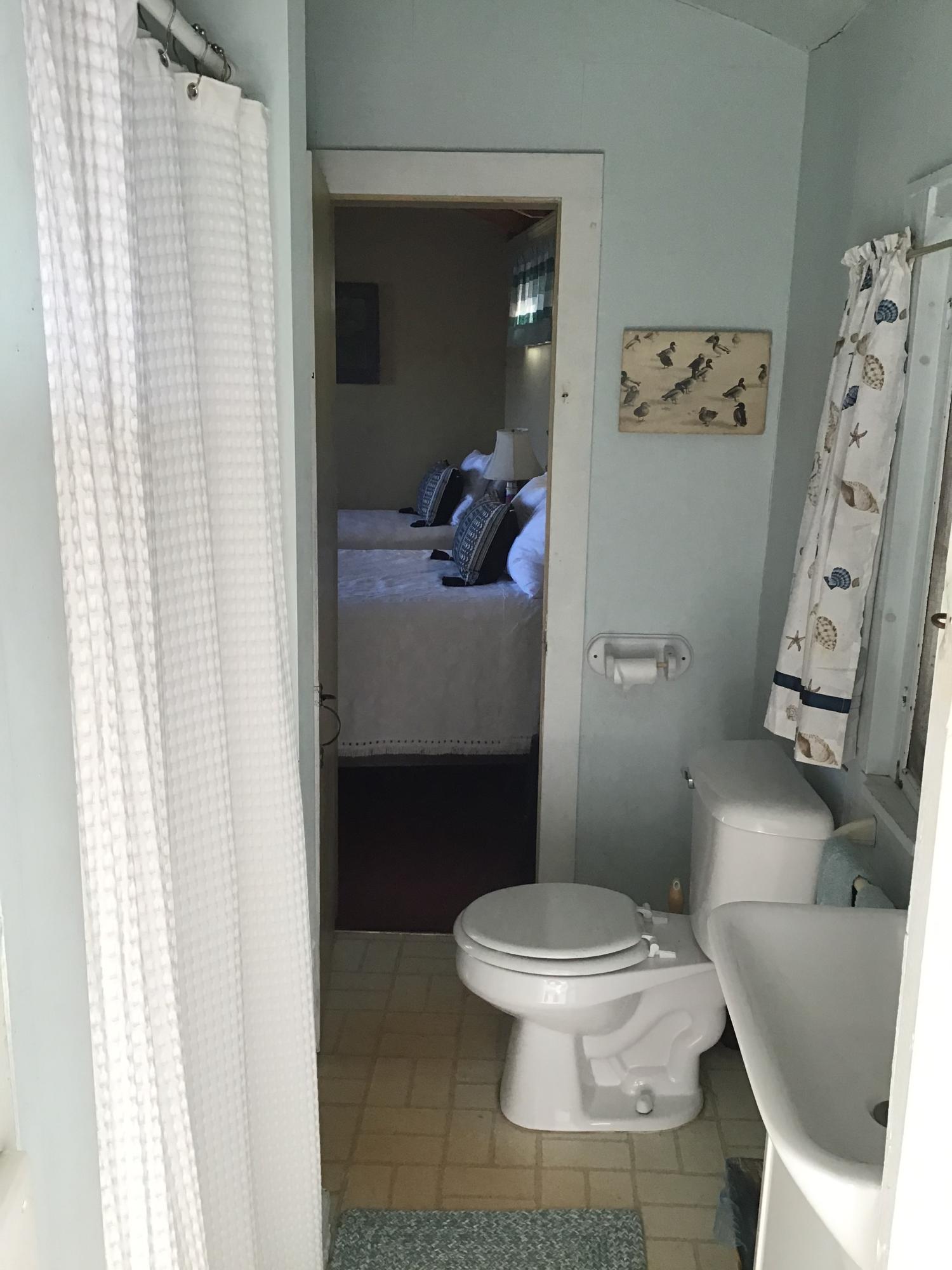 10 Lower County Road Dennis Port, MA 02639 - Photo 20 of 25 a white toilet sitting next to a shower curtain