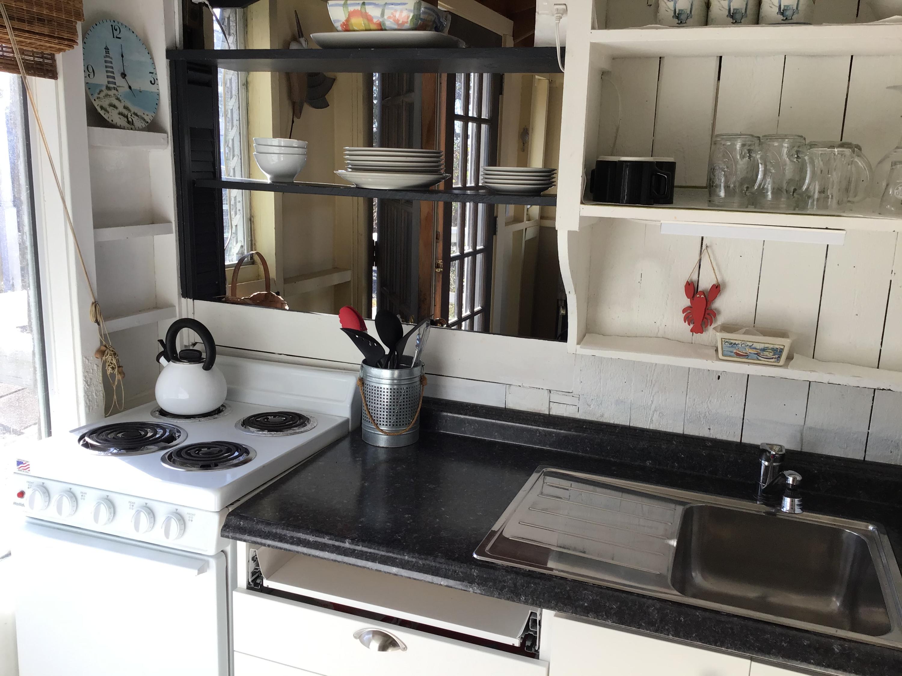 10 Lower County Road Dennis Port, MA 02639 - Photo 21 of 25 a kitchen with a sink and a stove