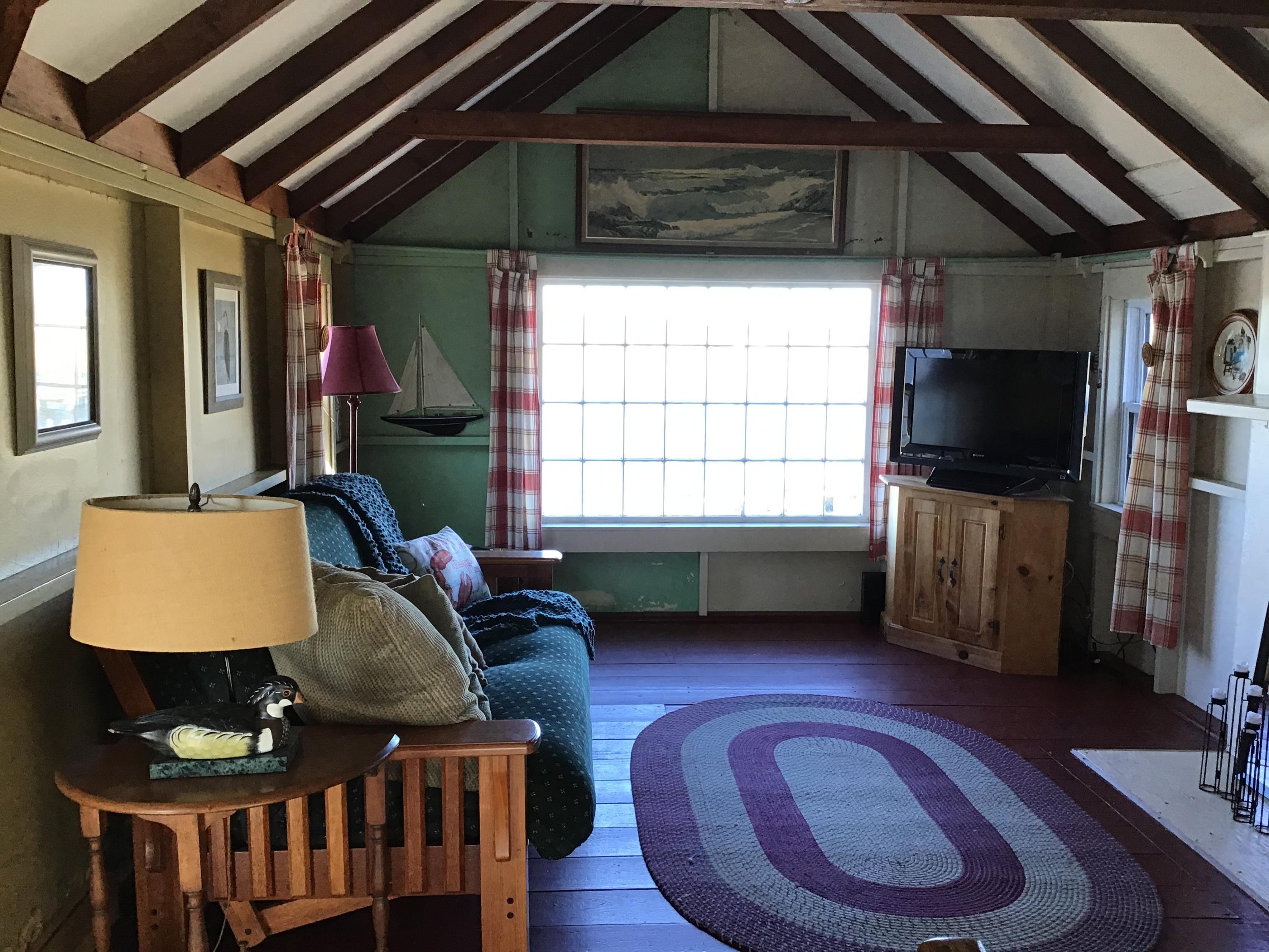 10 Lower County Road Dennis Port, MA 02639 - Photo 10 of 25 a living room with furniture a window and a flat screen tv
