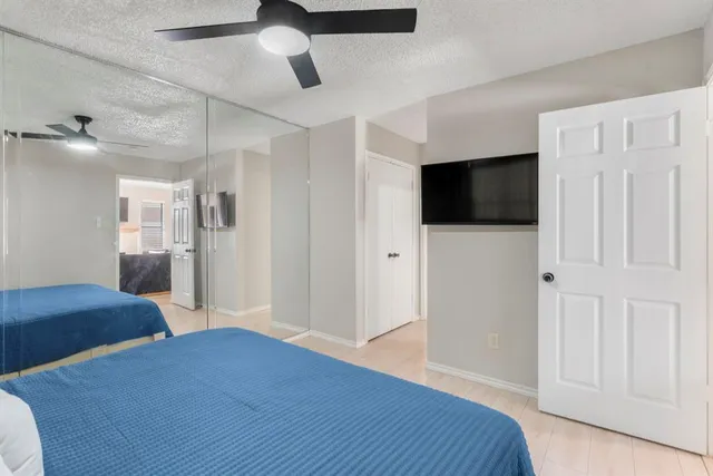 a bathroom with double vanity sinks a toilet a mirror and shower