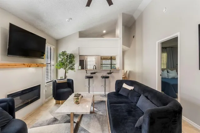 a living room with furniture and a potted plant