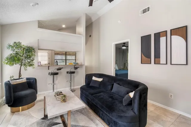 a kitchen with a table chairs refrigerator and a window