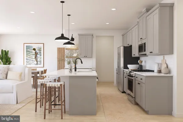 a kitchen with stainless steel appliances kitchen island a stove a sink a refrigerator and a center island