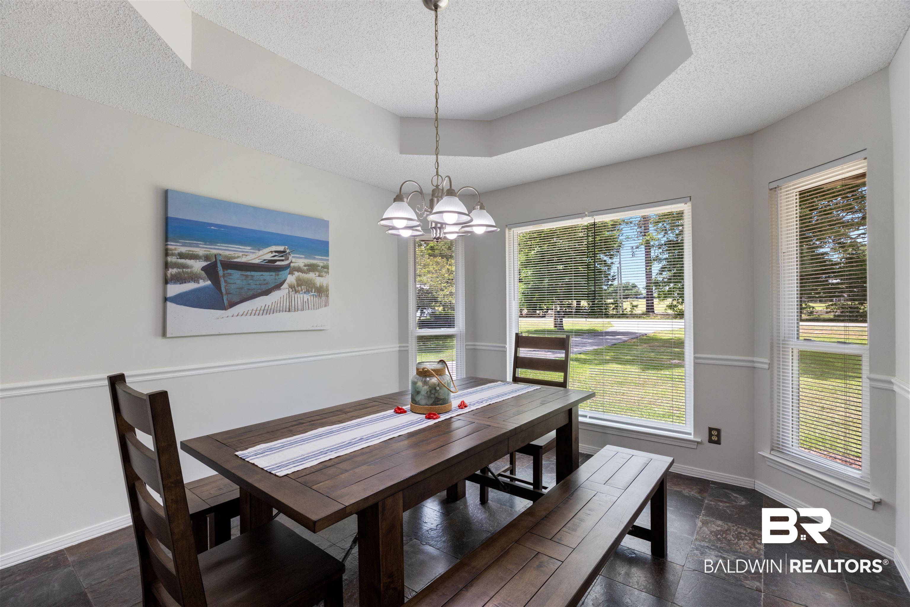 9771 Clarke Ridge Road Foley, AL 36535 - Photo 35 of 72 Dining area featuring a textured ceiling, plenty of natural light, baseboards, and stone tile flooring.