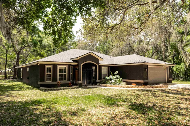 a kitchen with stainless steel appliances granite countertop a sink a stove and refrigerator