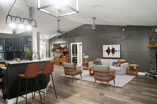 a kitchen with stainless steel appliances kitchen island granite countertop a refrigerator stove and oven