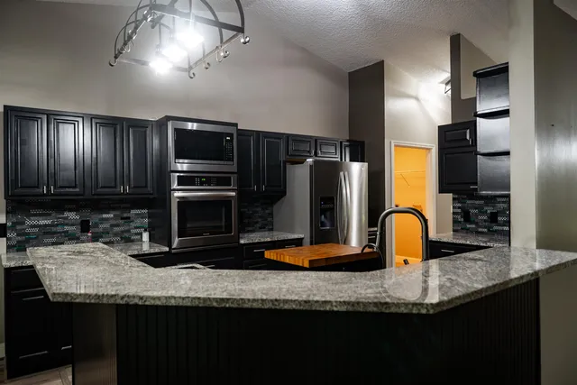 an empty room with windows and ceiling fan