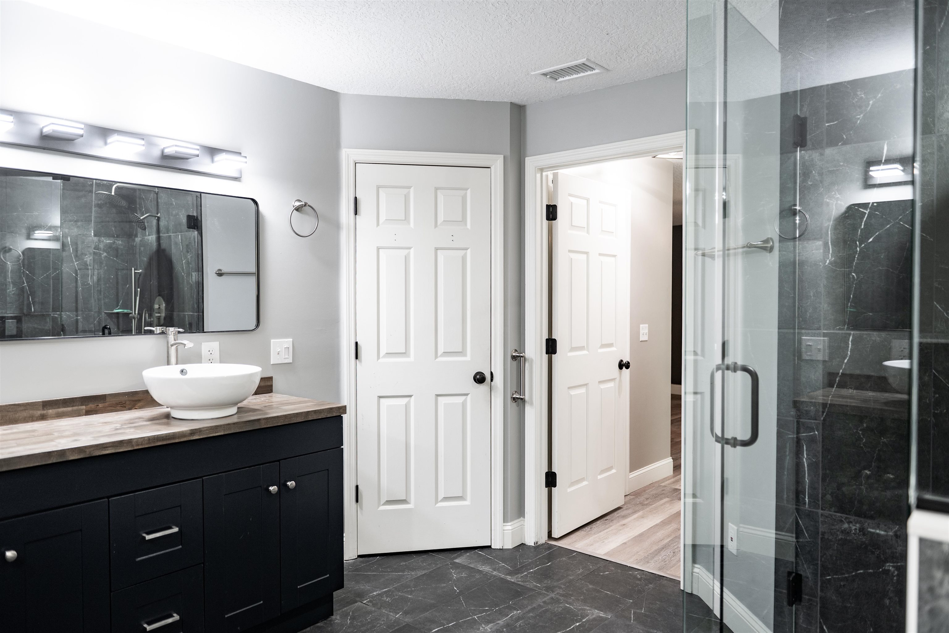 2950 Kings Road St. Augustine, FL 32086 - Photo 29 of 42 a bathroom with a double vanity sink mirror and shower