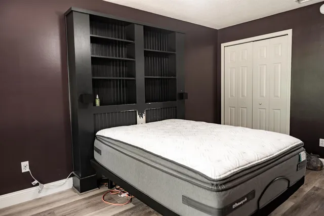 a view of a room with wooden floor