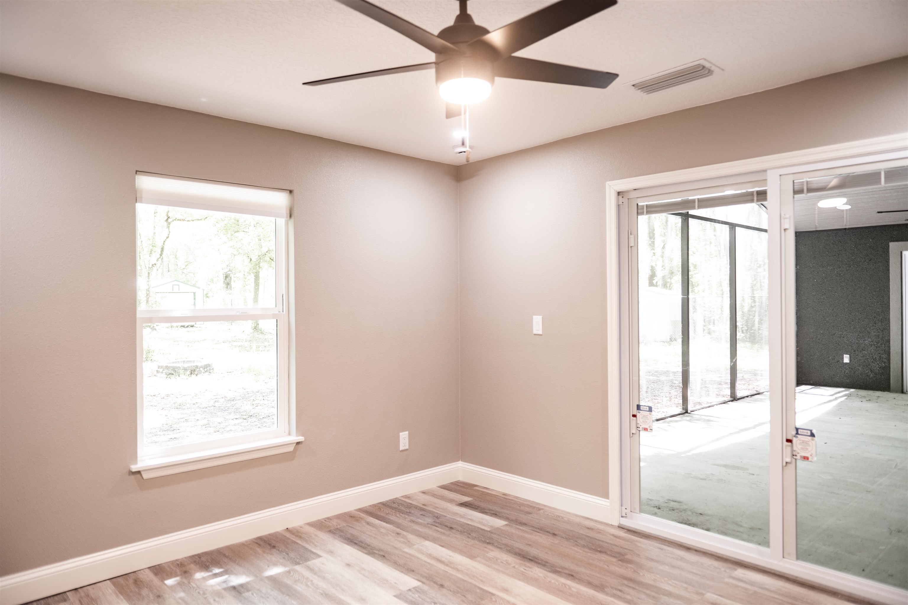 2950 Kings Road St. Augustine, FL 32086 - Photo 40 of 42 a view of an empty room with window and a chandelier fan
