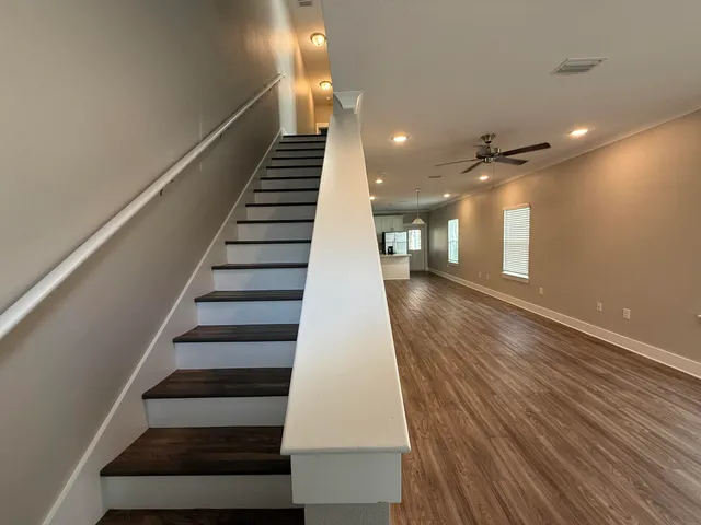 a view of entryway and hall with wooden floor