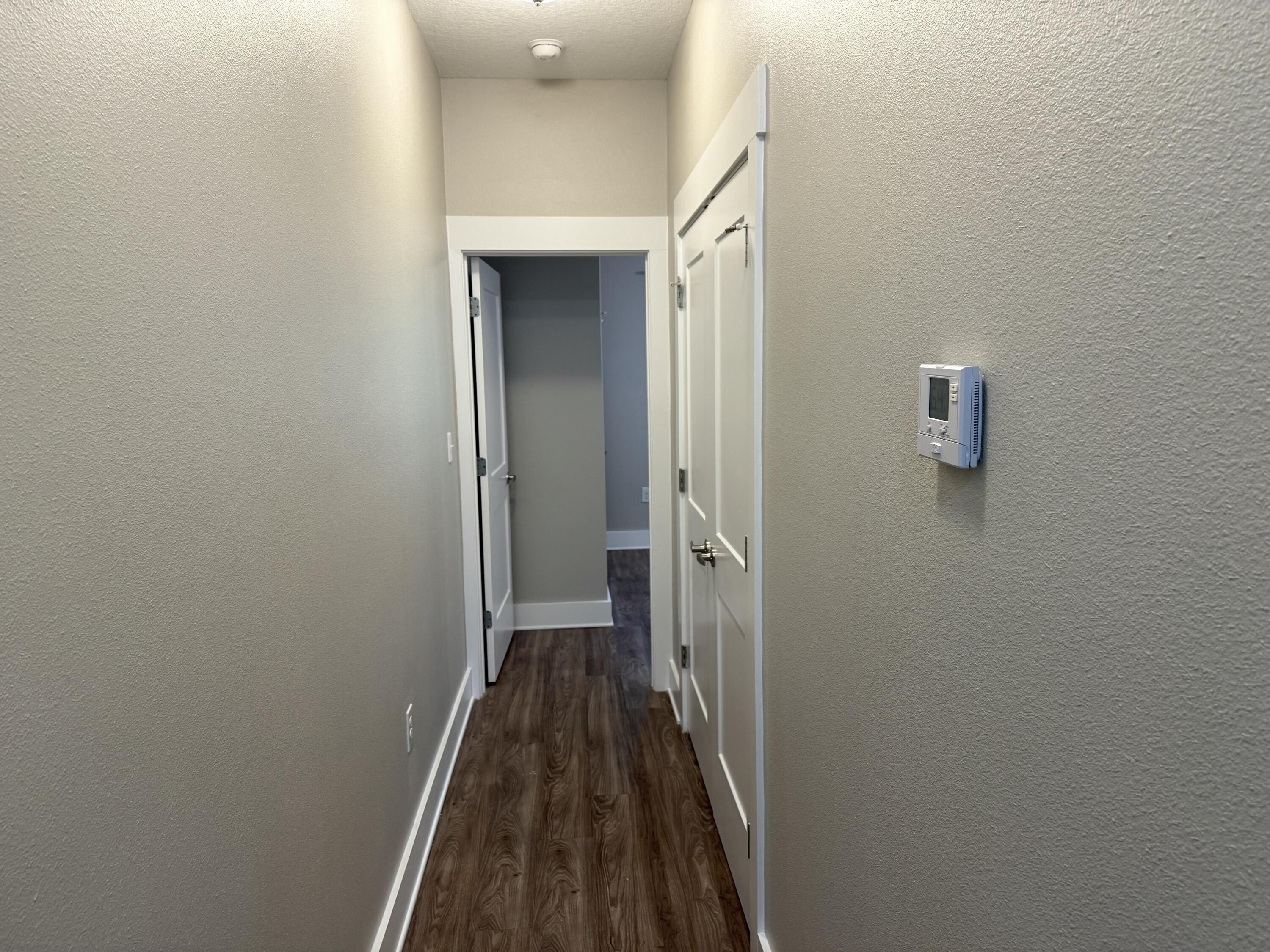 142 North Sand Palm Road Freeport, FL 32439 - Photo 21 of 26 a view of a hallway with wooden floor and a hallway