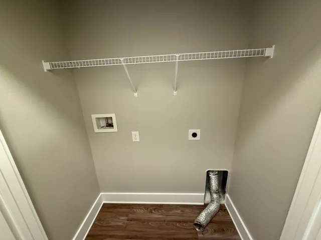 a view of a room with wooden floor