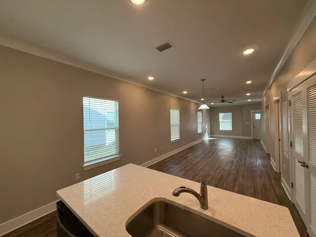 a room with pool table and windows