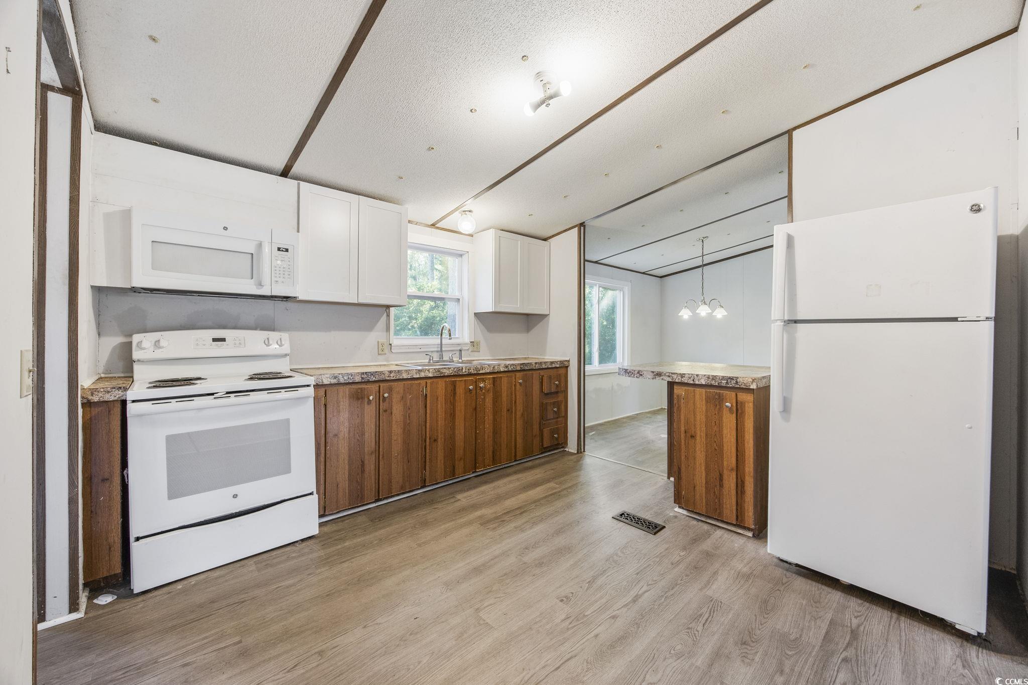 167 Offshore Drive Murrells Inlet, SC 29576 - Photo 12 of 33 Kitchen with white appliances, light wood-style fl