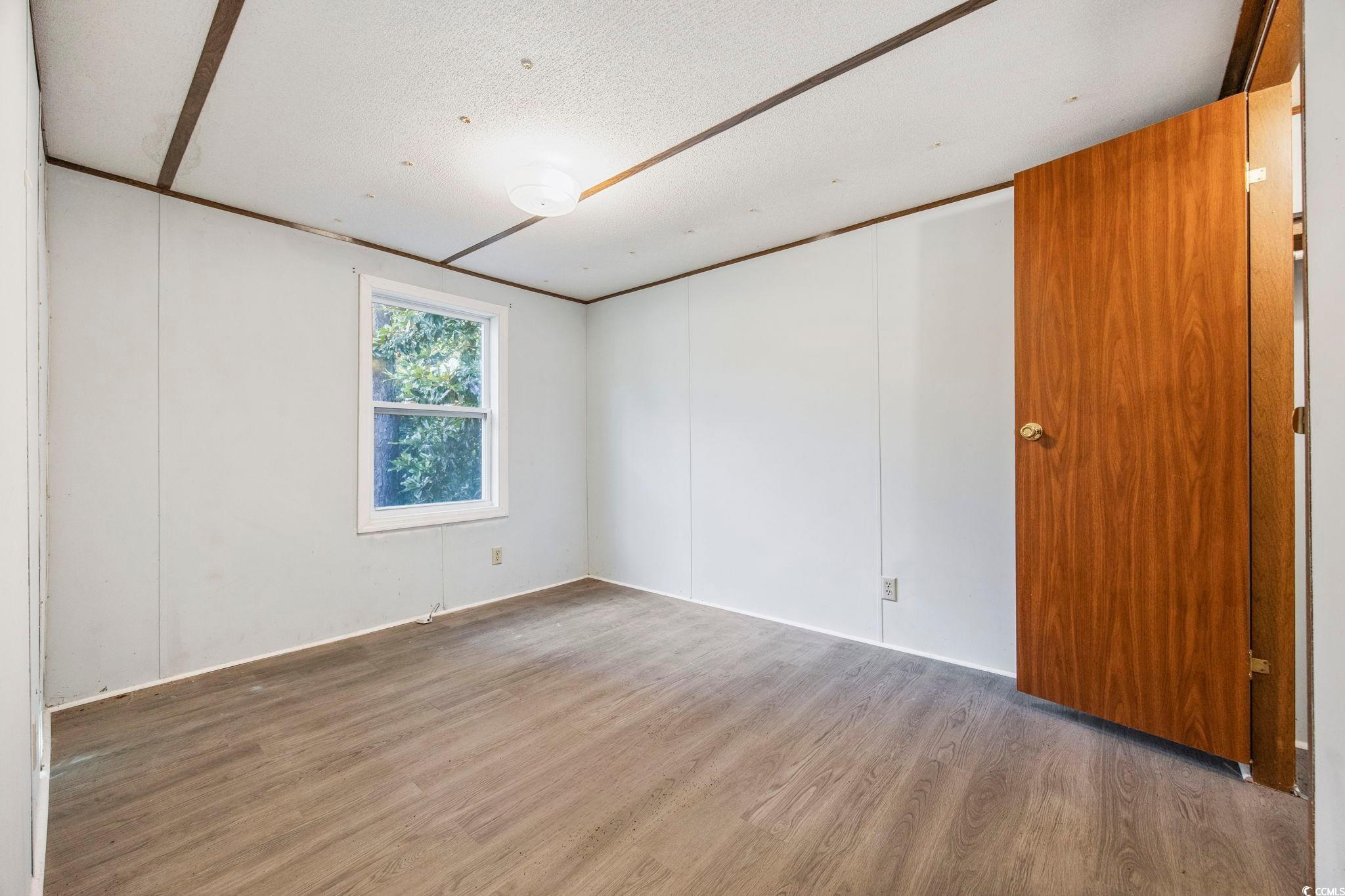 167 Offshore Drive Murrells Inlet, SC 29576 - Photo 18 of 33 Empty room with wood finished floors