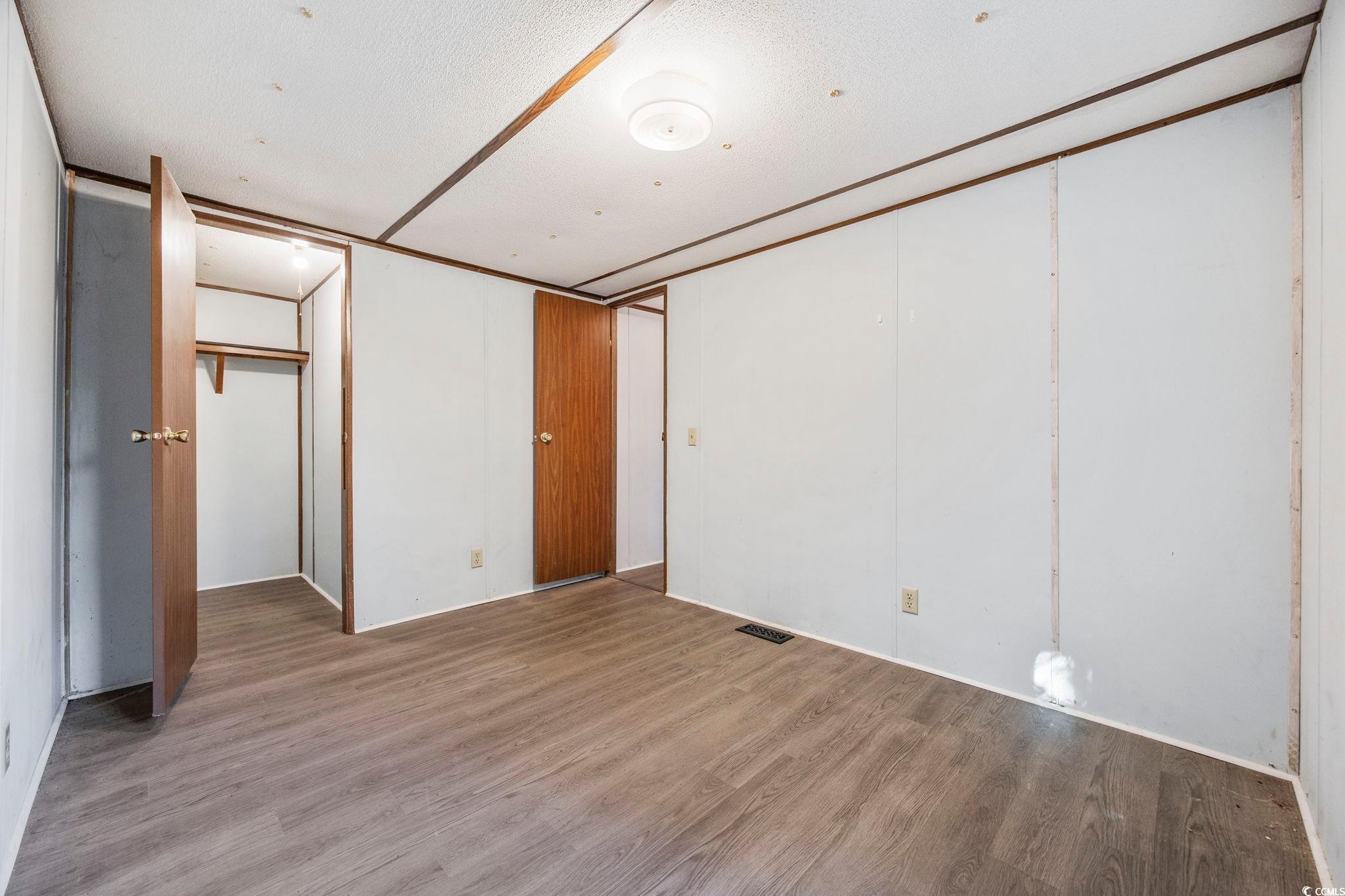 167 Offshore Drive Murrells Inlet, SC 29576 - Photo 19 of 33 Unfurnished bedroom featuring wood finished floors