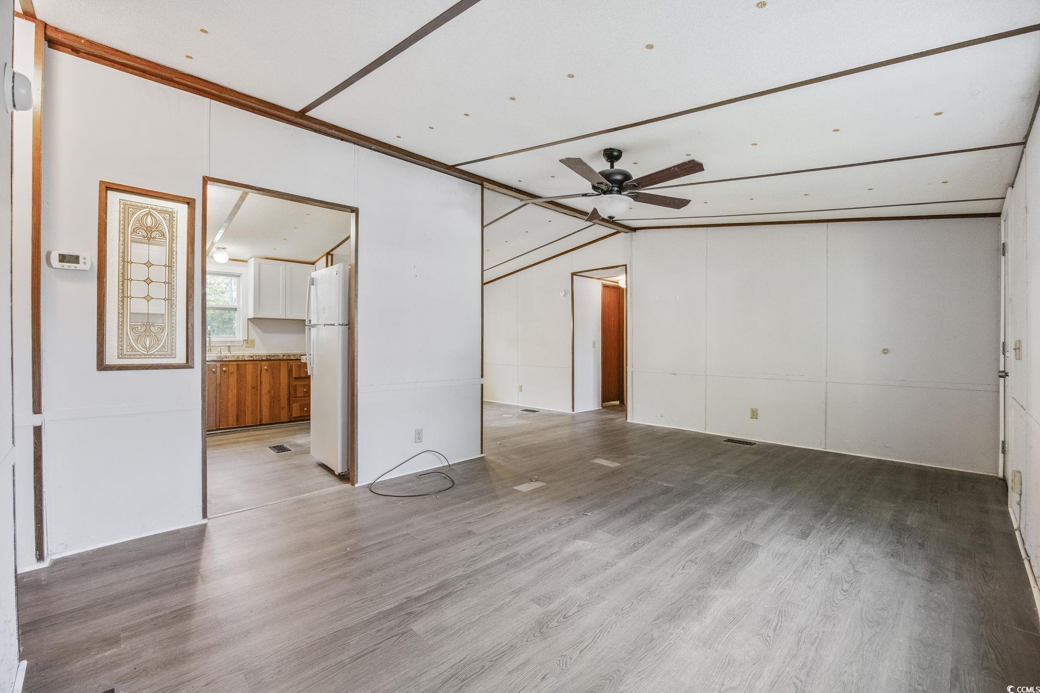 167 Offshore Drive Murrells Inlet, SC 29576 - Photo 5 of 33 Unfurnished living room featuring ceiling fan, woo