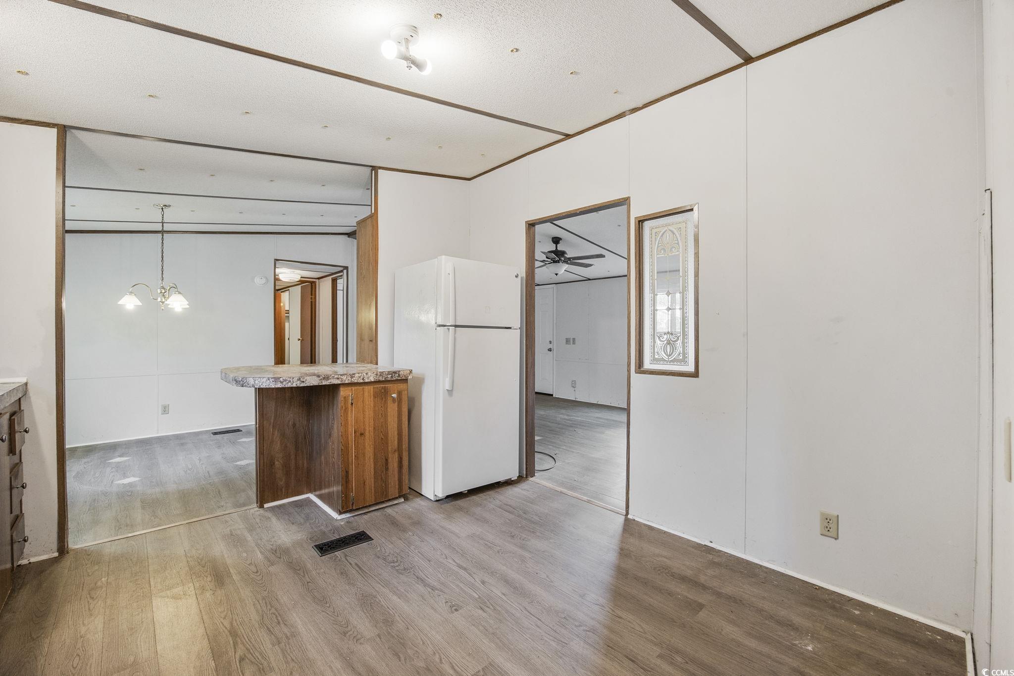 167 Offshore Drive Murrells Inlet, SC 29576 - Photo 9 of 33 Unfurnished room with wood finished floors, a chan