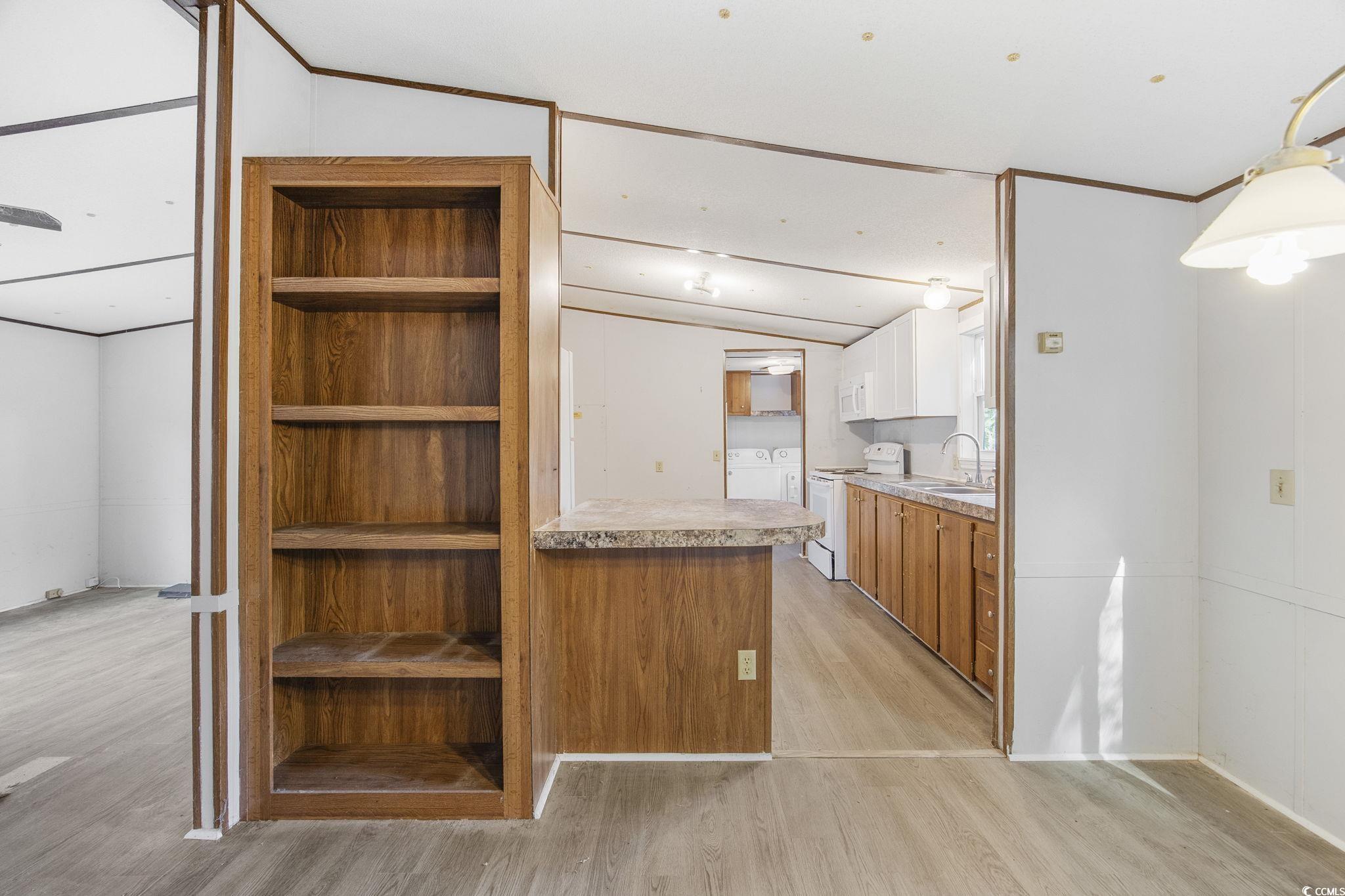167 Offshore Drive Murrells Inlet, SC 29576 - Photo 10 of 33 Kitchen featuring a sink, light wood finished floo