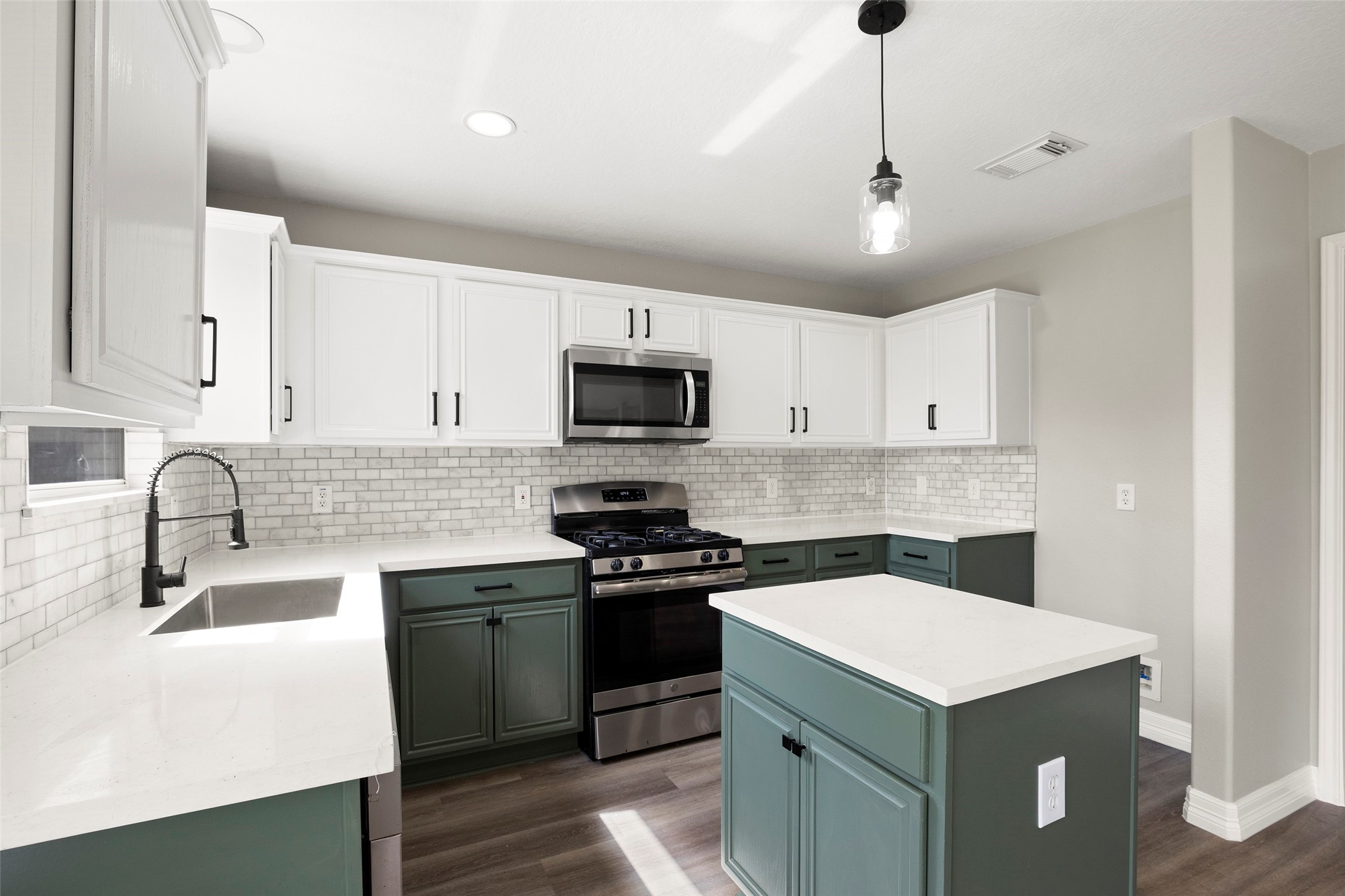 2406 Pinpoint Drive Spring, TX 77373 - Photo 15 of 25 a kitchen with a sink a stove and cabinets