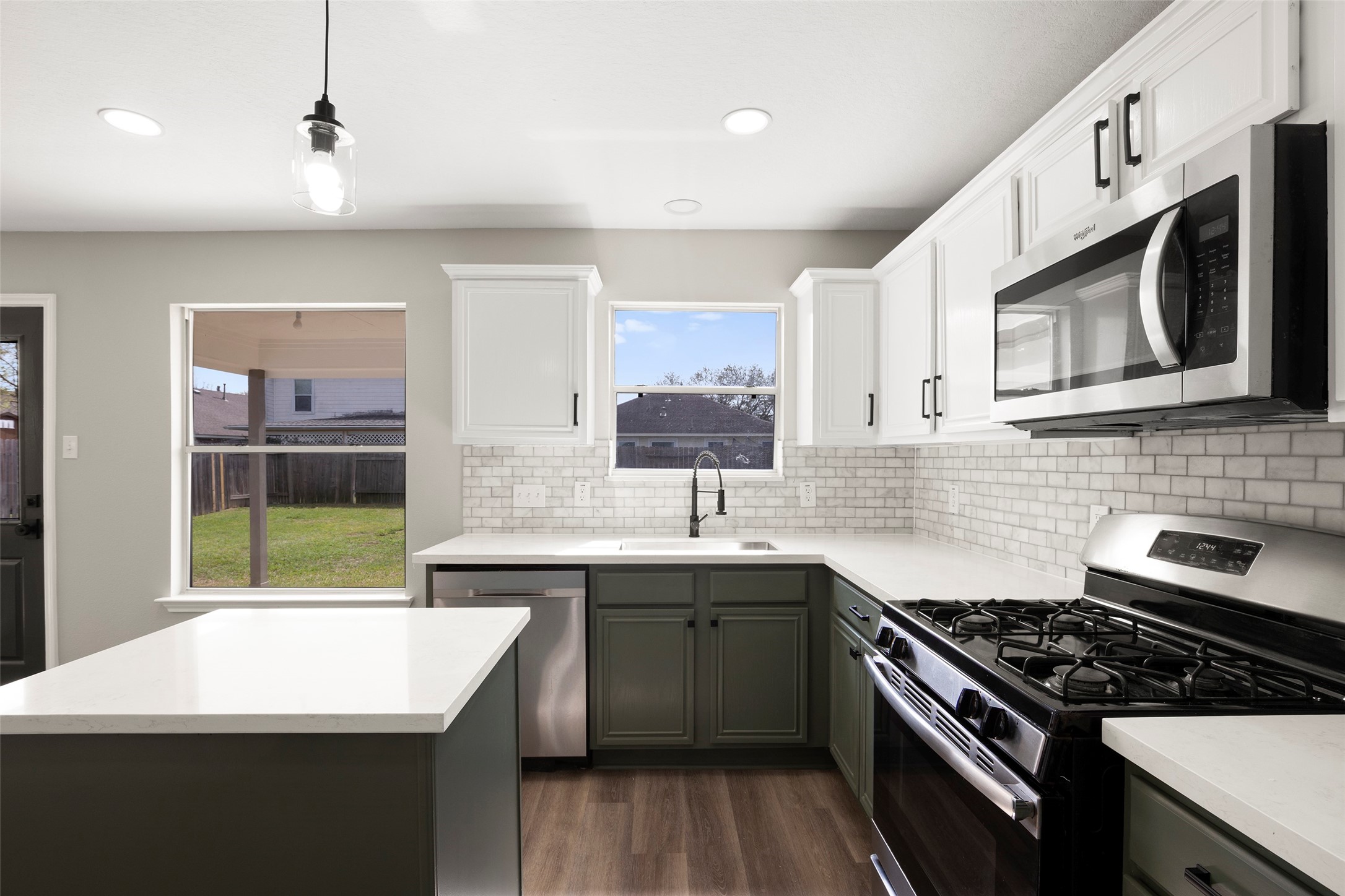 2406 Pinpoint Drive Spring, TX 77373 - Photo 16 of 25 a kitchen with stainless steel appliances a sink a stove a microwave a sink and cabinets