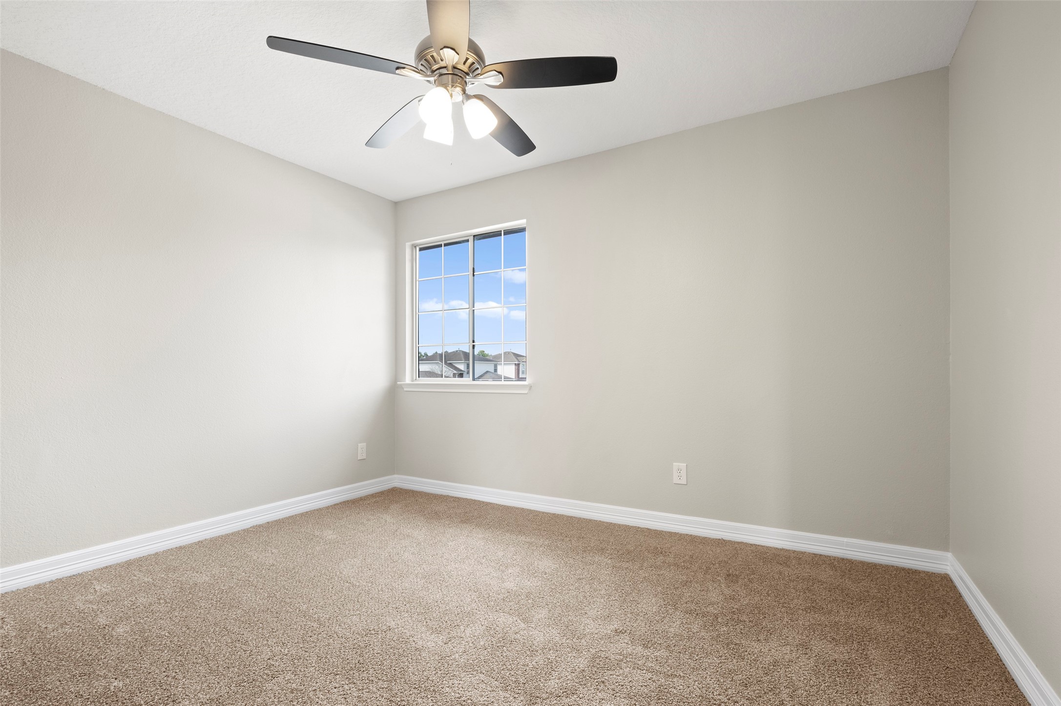 2406 Pinpoint Drive Spring, TX 77373 - Photo 18 of 25 an empty room with a window and ceiling fan