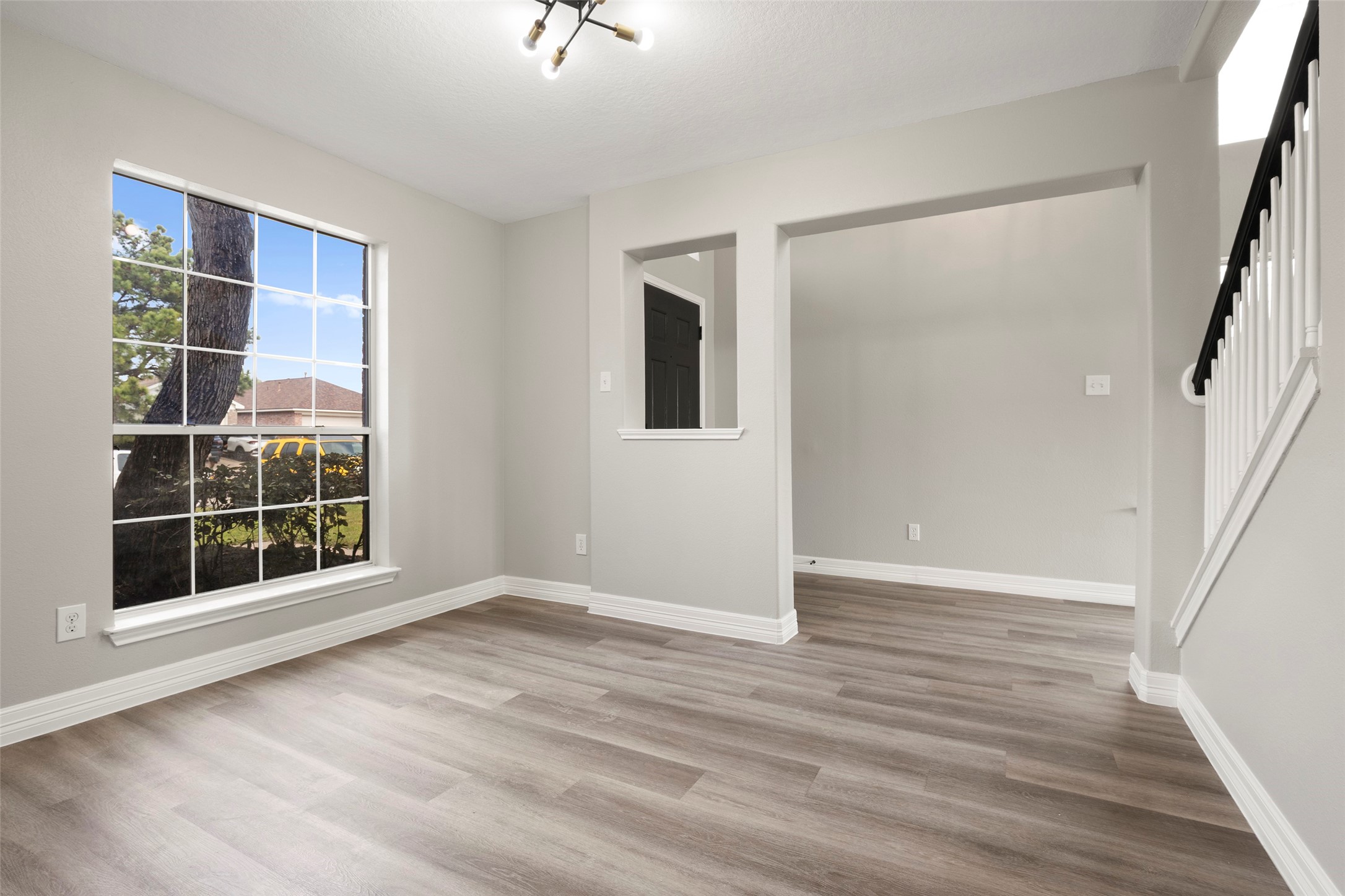 2406 Pinpoint Drive Spring, TX 77373 - Photo 4 of 25 a view of an empty room with wooden floor and windows