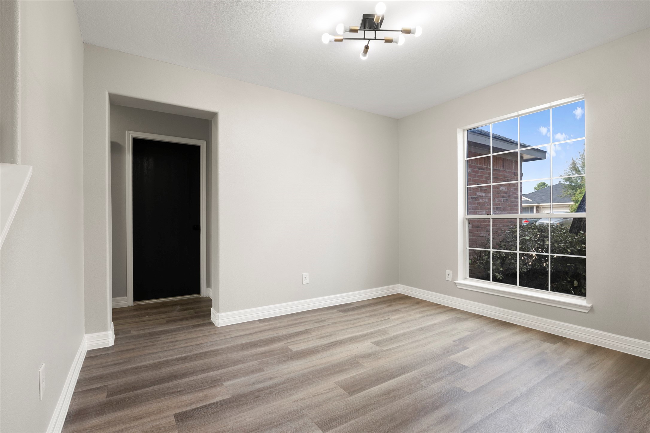 2406 Pinpoint Drive Spring, TX 77373 - Photo 5 of 25 an empty room with wooden floor cabinet and windows