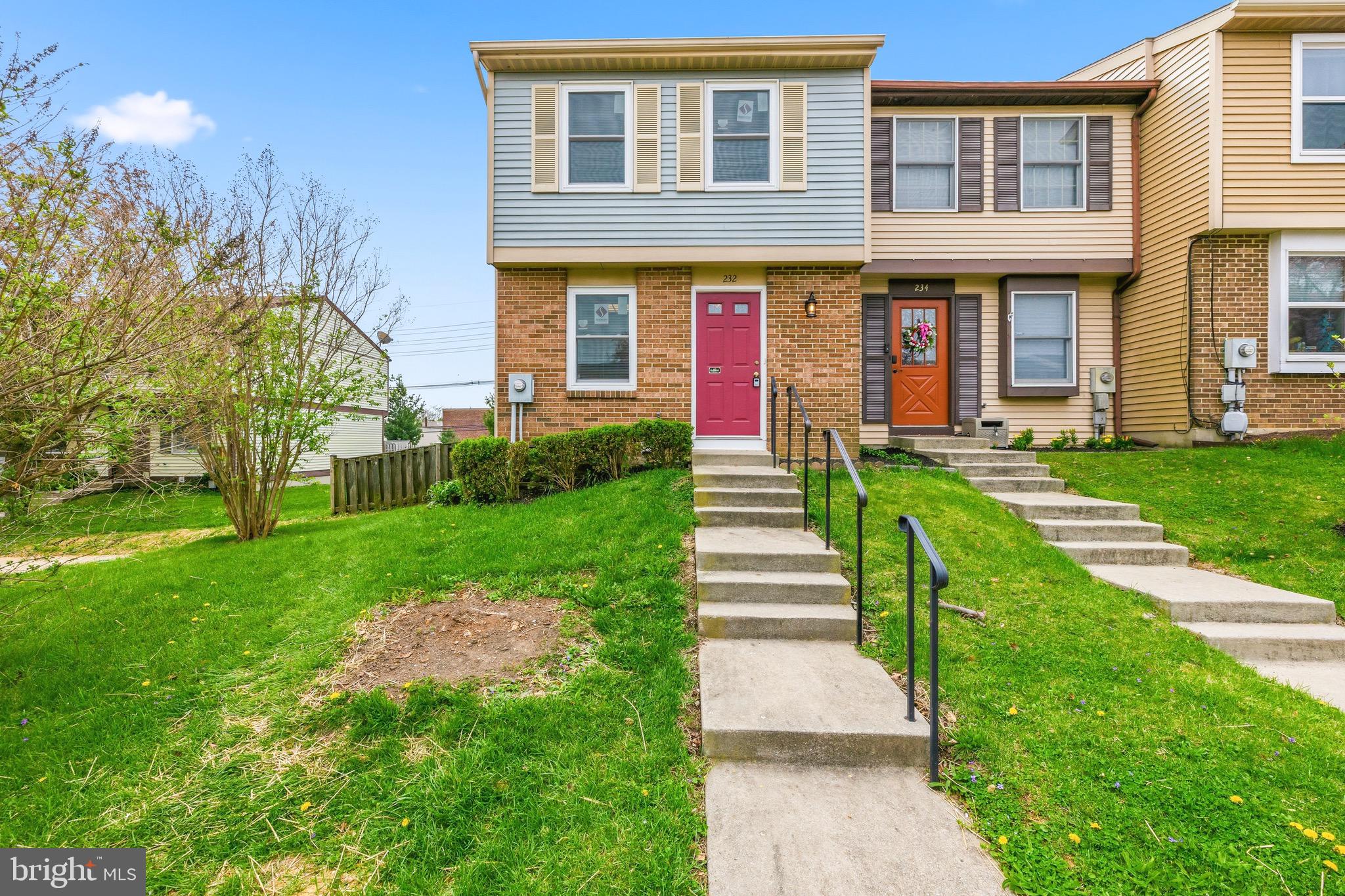 232 Canfield Terrace Frederick, MD 21702 - Photo 1 of 30 a view of a brick house with a yard and plants next to a yard